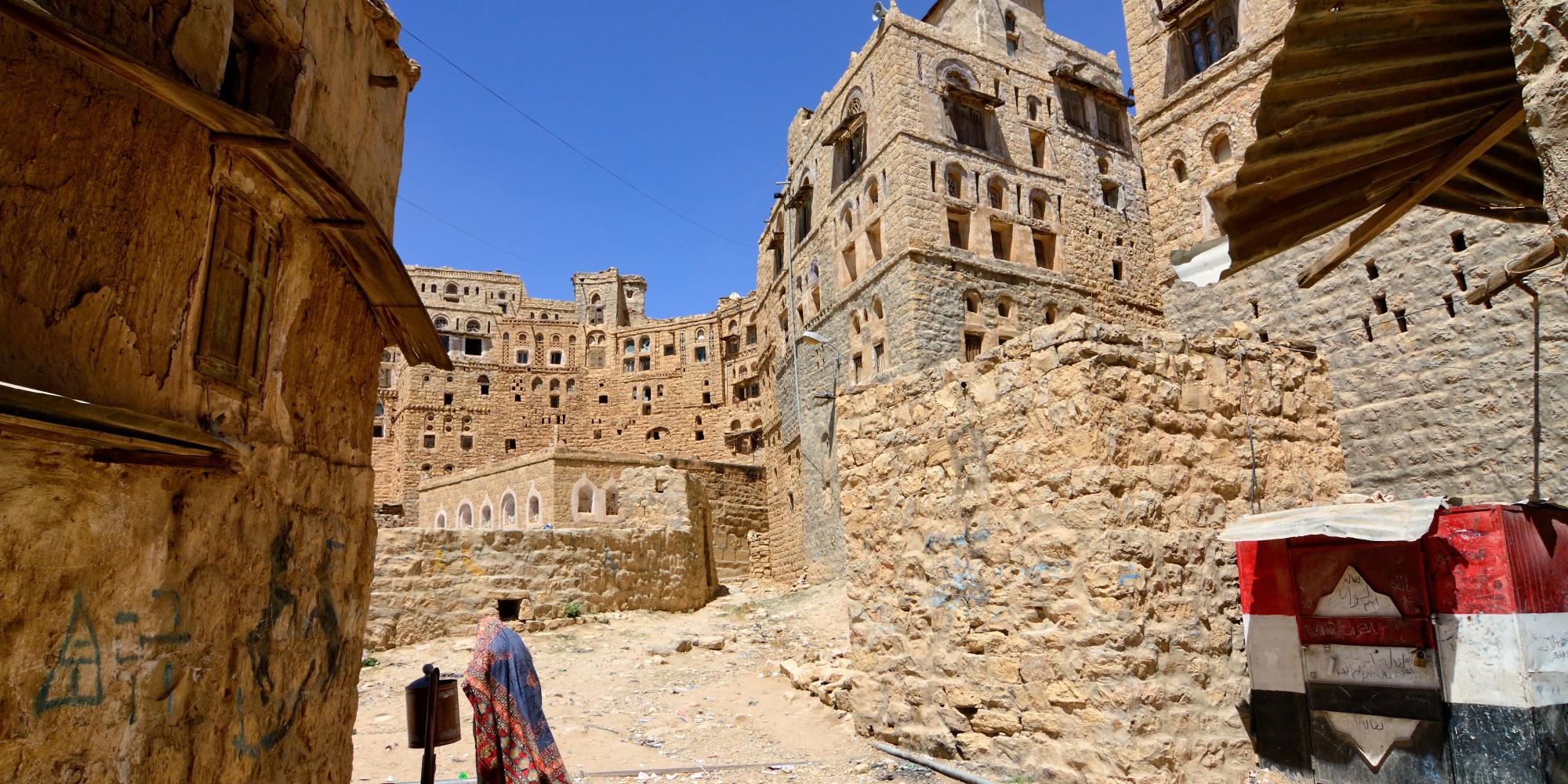 Woman walking through Yemeni village